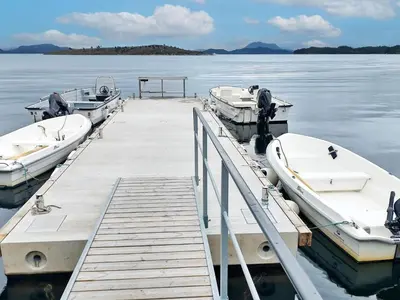 two boats are docked at a dock in the water at 6 person holiday home in Onarheim in Onarheim