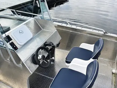a boat with two chairs and a steering wheel on it at 8 person holiday home in FREI in Frei
