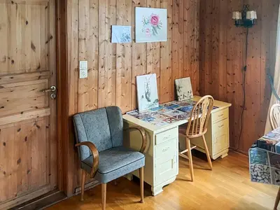 a desk and chair in a room with wooden walls at 3 person holiday home in STRYN-By Traum in Stryn
