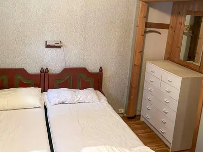 a bedroom with two beds and a dresser and a mirror at 3 person holiday home in STRYN-By Traum in Stryn