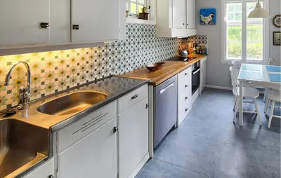 a kitchen with white cabinets and a sink and a table at 6 Bedroom Lovely Home In Holmedal in Holmedal