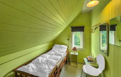 a bedroom with a bed in a green room at 6 Bedroom Lovely Home In Holmedal in Holmedal