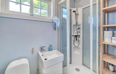 a bathroom with a toilet and a sink and a shower at 6 Bedroom Lovely Home In Holmedal in Holmedal