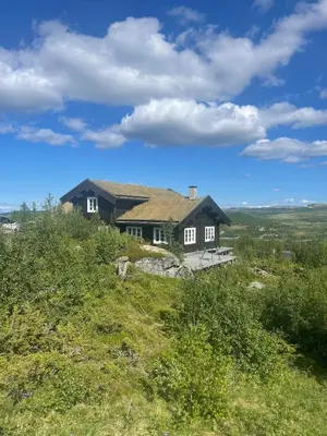 a house sitting on top of a hill at Great cabin with gorgeous mountain views in Dagali