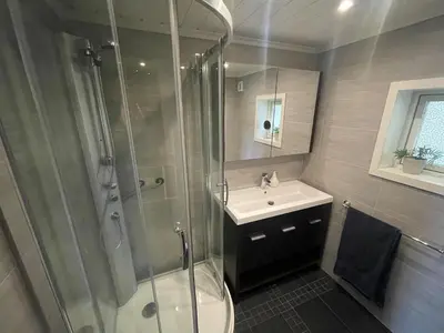 a bathroom with a shower and a sink at Great cabin with gorgeous mountain views in Dagali