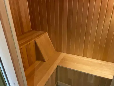 a small wooden sauna with a wooden bench in it at Great cabin with gorgeous mountain views in Dagali