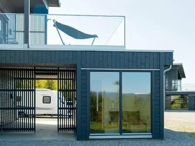 a building with glass doors and a window at 10 person holiday home in INDERØY-By Traum in Kjerkenesvåg
