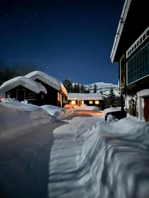 a snow covered street in front of a building at night at Ski lodge 7 min from Hemsedal Ski Center by Car in Fausko