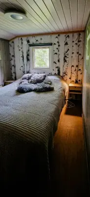 a bedroom with a large bed with a window at Mountain Cabin With Panoramic Views In Brakastølen in Ron