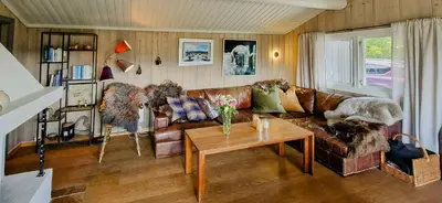 a living room with a couch and a table at Mountain Cabin With Panoramic Views In Brakastølen in Ron