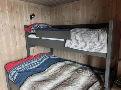 a room with two bunk beds in a cabin at Harevadet 217 in Volda