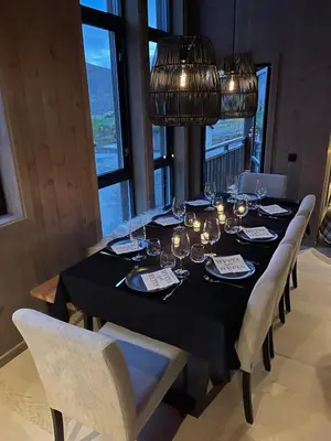 a dining room table with a black table cloth and chairs at Harevadet 217 in Volda