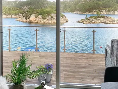 a balcony with a view of a body of water at 8 person holiday home in Urangsvåg in Ervik