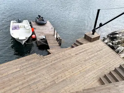 a small boat is docked at a wooden dock at 8 person holiday home in Urangsvåg in Ervik