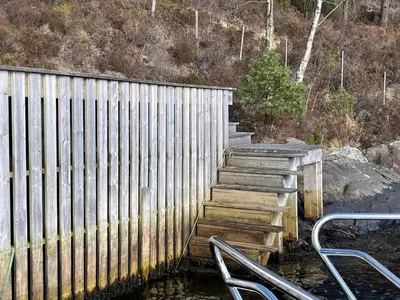 a set of wooden stairs next to a fence at 6 person holiday home in Rubbestadneset in Rubbestadneset