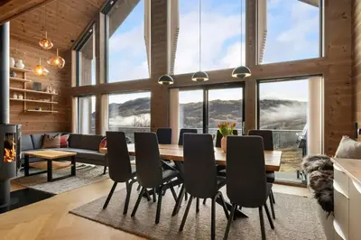 a dining room with a table and chairs at Panoramahytte med fjellutsikt in Sogndal