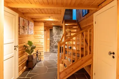 a staircase in a log home with wooden ceilings at Trysilfjellet Nord 901 in Trysil