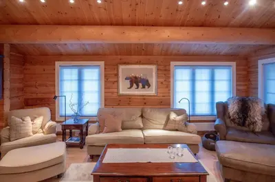 a living room with two couches and a table at Trysilfjellet Nord 901 in Trysil