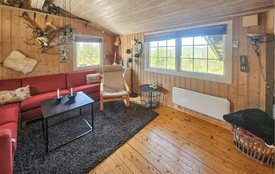 a living room with a red couch and a table at 3 Bedroom Lovely Home In Dagali in Dagali