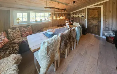 a dining room with a long table and a couch at 3 Bedroom Lovely Home In Dagali in Dagali
