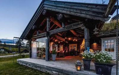 a log cabin with a porch and a deck at Awesome Home In Flesberg With Sauna in Flesberg