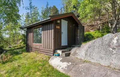 a small cabin with a door on a hill at Idyllic cottage with a view, close to Gardermoen Airport in Hurdal