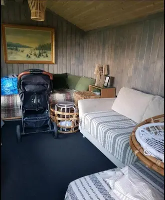 a bedroom with two beds and a stroller in it at Idyllic cottage with a view, close to Gardermoen Airport in Hurdal