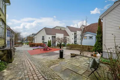 a yard with houses and a brick driveway at Charming apt in the centre of Bergen in Bergen