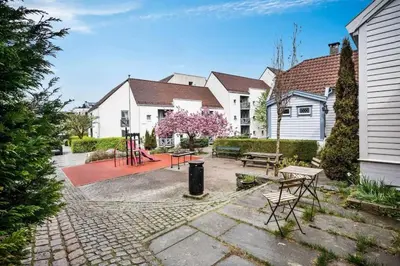 a backyard with tables and chairs and houses at Historic retreat in the middle of town in Bergen
