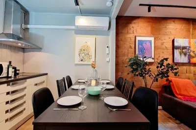 a dining room with a table and a kitchen at Historic townhouse - 2 baths 3 floors 100 percent charm in Bergen