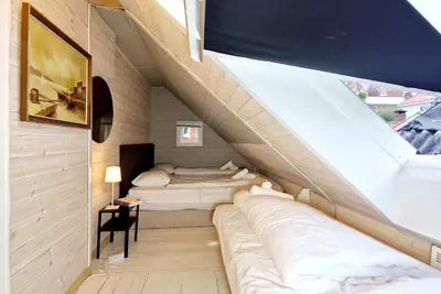 a room with two beds and a staircase at Historic townhouse - 2 baths 3 floors 100 percent charm in Bergen
