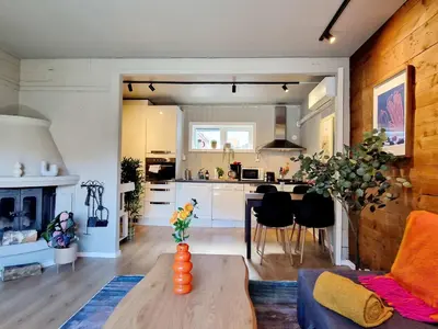 a living room with a table and a kitchen at Historic townhouse - 2 baths 3 floors 100 percent charm in Bergen