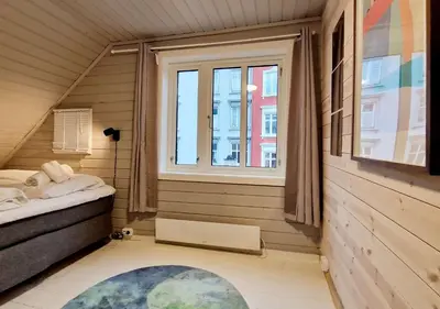 a small room with a bed and a window at Historic charm in the heart of Bergen in Bergen
