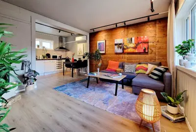 a living room with a couch and a table at Historic charm in the heart of Bergen in Bergen