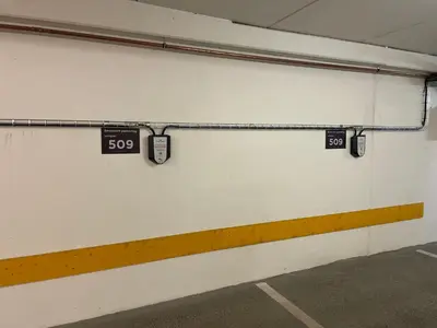 a white wall with two signs on it at Sentral Og Moderne Leilighet Med Heis Og Garasje in Beitostøl