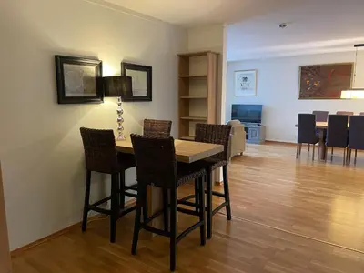 a dining room with a table and chairs at Sentral Og Moderne Leilighet Med Heis Og Garasje in Beitostøl
