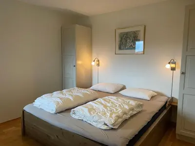 a bed in a room with two pillows on it at Sentral Og Moderne Leilighet Med Heis Og Garasje in Beitostøl