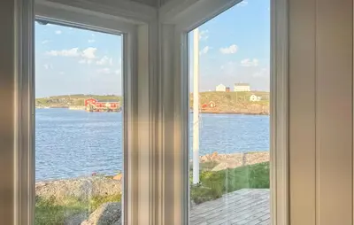 a window in a room with a view of the water at Nice Home In Sauøya With House Sea View