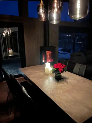 a table with a candle and a vase with flowers at Brand new house close 2 Skiresort in Hemsedal