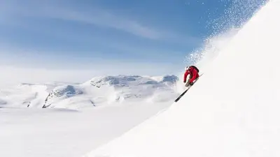 a person is skiing down a snow covered slope at Brand new house close 2 Skiresort in Hemsedal