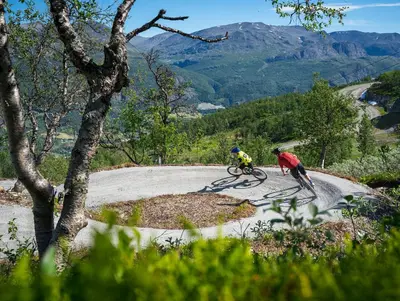 two people riding bikes on a mountain road at Brand new house close 2 Skiresort in Hemsedal