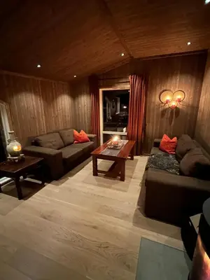 a living room with a couch and a table at Cozy little cottage for rent in Oppheim in Ål
