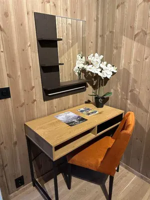 a wooden desk with a chair and a mirror at Cozy little cottage for rent in Oppheim in Ål