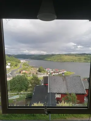a view of a lake from a window at The top half of a house with sea view in Steinkjer
