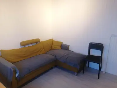a bed and a chair in a room at The top half of a house with sea view in Steinkjer