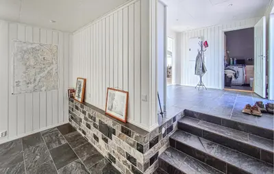 a room with stairs and a map on the wall at Beautiful Home In Fitjar With House Sea View in Fitjar