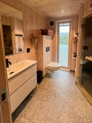 a bathroom with a tub and a toilet and a sink at Architect-Designed Cabin With Views Of Sigdal in Eggedal