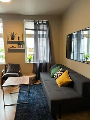 a living room with a couch and a table at Cozy place in the city center, Bergen! in Lii