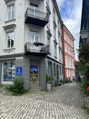a building with a balcony on a cobblestone street at Cozy place in the city center, Bergen! in Lii