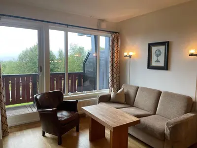 a living room with a couch and a table and a window at Leilighet for 4 i sentrum in Beitostøl